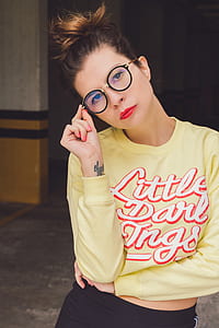 woman holding eyeglasses with black frames while taking selfie thumbnail