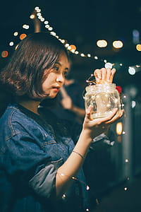 Photo of Woman Holding Jar With String Lights thumbnail