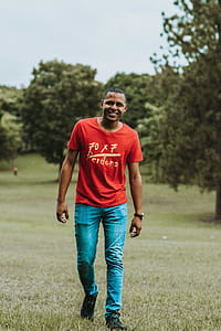 Photo of Man Walking Grass Field thumbnail