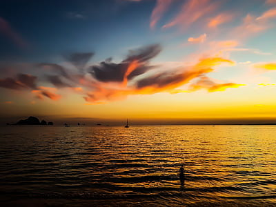 photo of body of water during sunset thumbnail