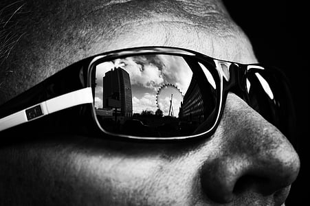 ferris wheel reflection on man's sunglasses thumbnail