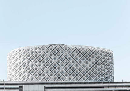 round gray concrete building under clear sky thumbnail