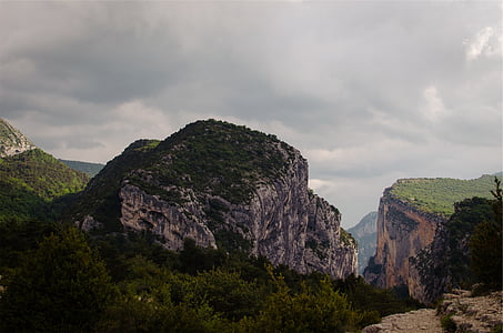 mountain terrain under white cloudy skies thumbnail