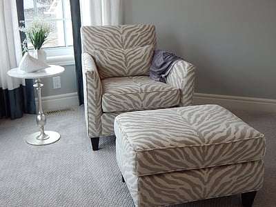 gray and beige zebra skin printed sofa chair with ottoman beside side table thumbnail
