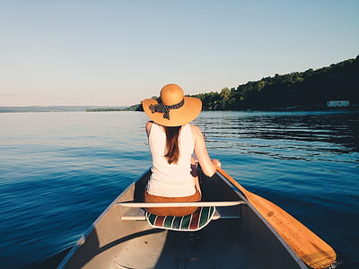 woman in kayak paddling in body of water thumbnail