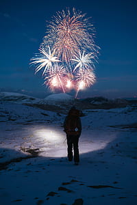 man on snow with fireworks on sky thumbnail
