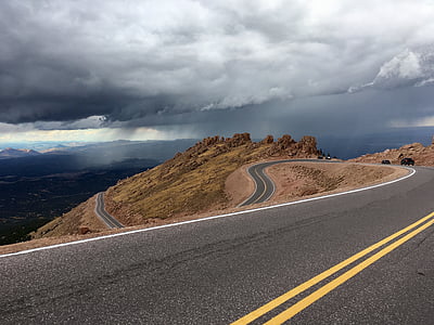 paved road under sky with cumulus clouds thumbnail