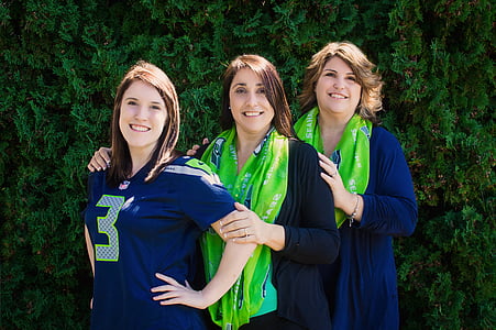 three women taking groupie next to pine tree during daytime thumbnail