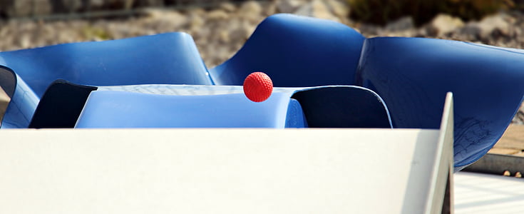 red ball over white panel near gray rail during daytime thumbnail