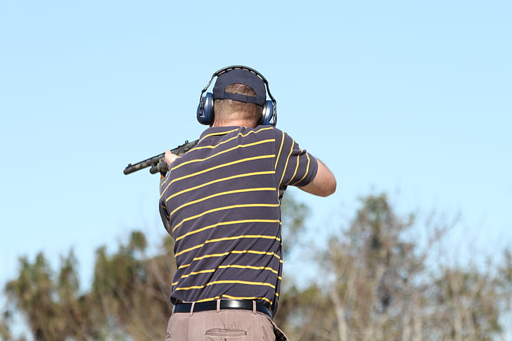 selective focus photography of man shooting