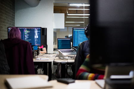two person in front of computer inside lighted room thumbnail