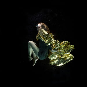 underwater photography of woman in green dress thumbnail