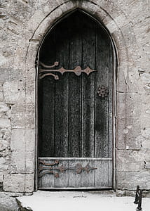black and grey wooden door of grey concrete building thumbnail