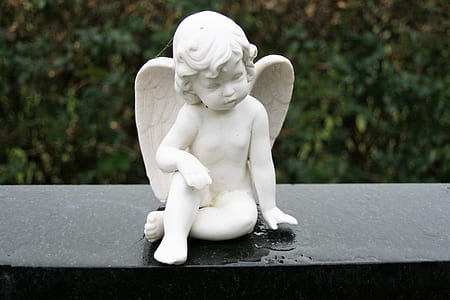 selective focus photography angel figurine thumbnail