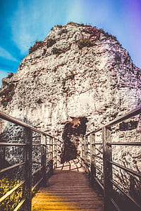 Brown Wodoen Boardwalk in Front of Gray Rocky Mountain Under Blue Sky thumbnail