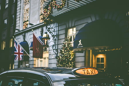 black taxi in front of gray concrete house thumbnail