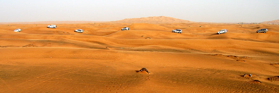 white and silver vehicle running on sand at daytime thumbnail