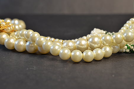 beaded white pearl jewelry on gray surface thumbnail