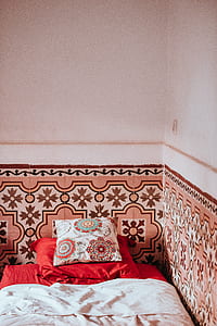 two throw pillows on bed sheet thumbnail