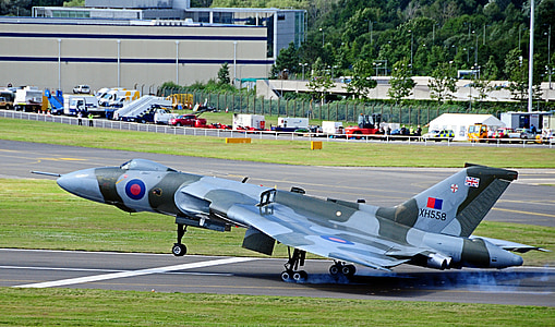 gray and black camouflage plane at daytime thumbnail