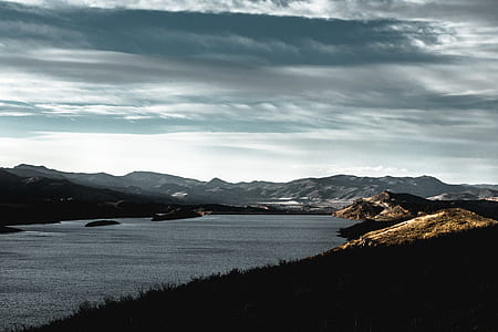 aerial photography of body of water surrounded by mountains thumbnail