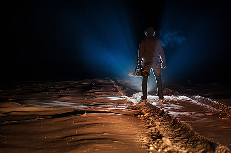 photo of man holding chainsaw thumbnail