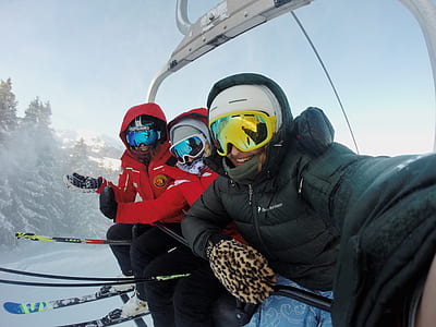 three people riding ski lift thumbnail