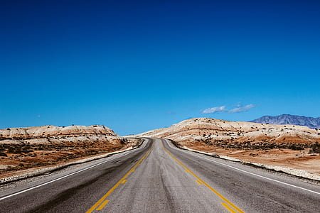gray road under the clear sky during daytime thumbnail