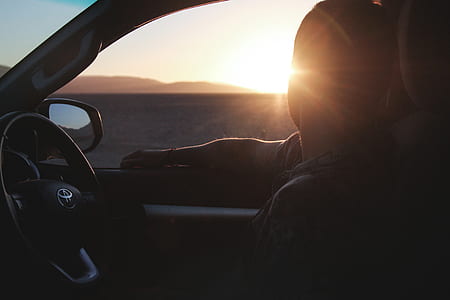man sitting in car staring at the sun thumbnail