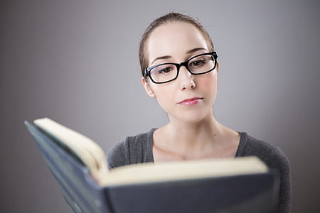 woman in front of black covered book thumbnail