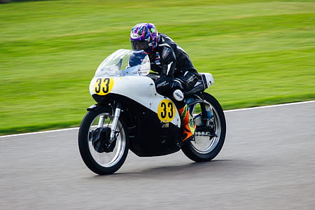 man driving white sports bike thumbnail