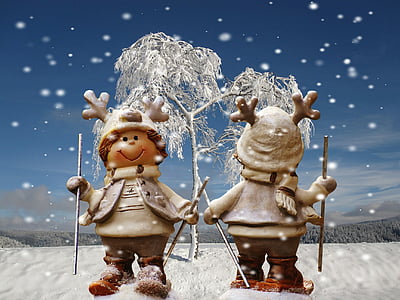 two snowman holding hands near white tree under blue sky during daytime thumbnail