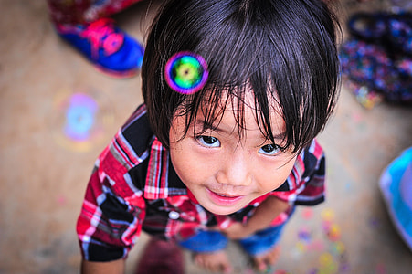toddler boy wearing top standing on ground beside water bubble during daytime thumbnail