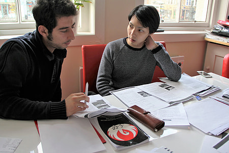 man and woman sitting near table with papers thumbnail