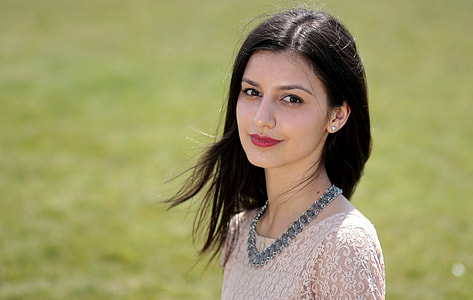 selective focus photography of woman standing on green grass thumbnail