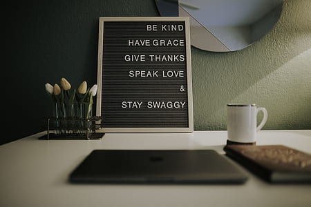 chalkboard leaning against wall near mug and laptop thumbnail