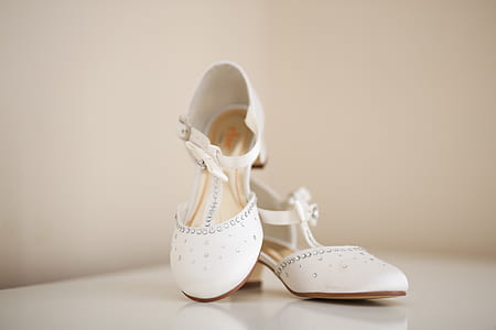 pair of women's white sandals beside white wall thumbnail