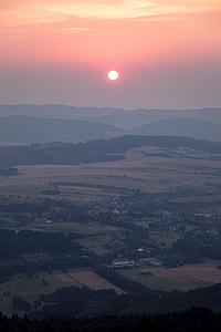 sun above mountain ranges thumbnail