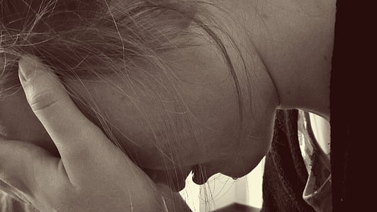 photo of woman holding her head thumbnail