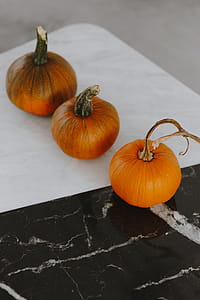 Orange halloween pumpkins on marble thumbnail