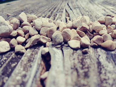 Pile of Beige Stone on Brown Wood Surface thumbnail