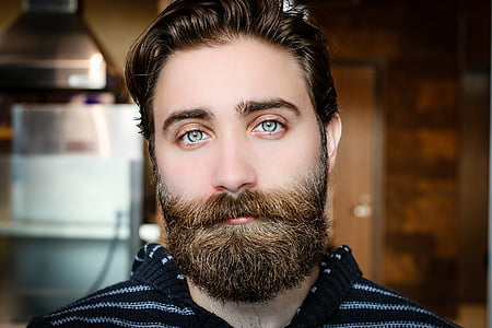man wearing black and white crochet top taking picture in close-up thumbnail
