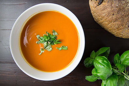 Bowl of tomato soup with basil and walnut bread thumbnail