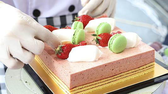 person putting strawberry on cake thumbnail