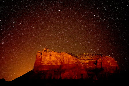 photography of rock formation under the stars thumbnail
