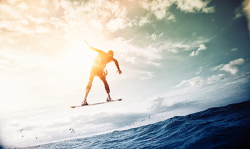 Man Wakeboarding over Body of Water thumbnail