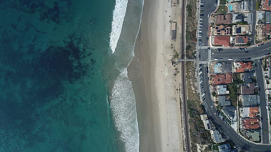 sea near road and buildings at daytime thumbnail