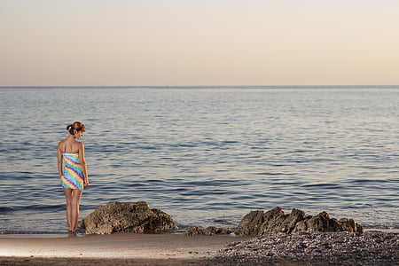 woman standing near body of water thumbnail