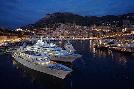two cruise ships near dock and city with turned on lights thumbnail
