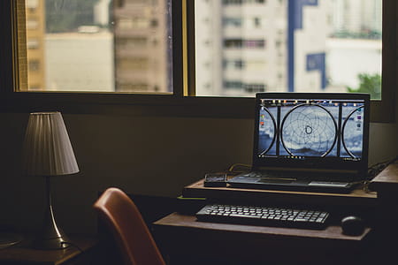 Black Laptop Computer Turned on Near Window at Daytime thumbnail